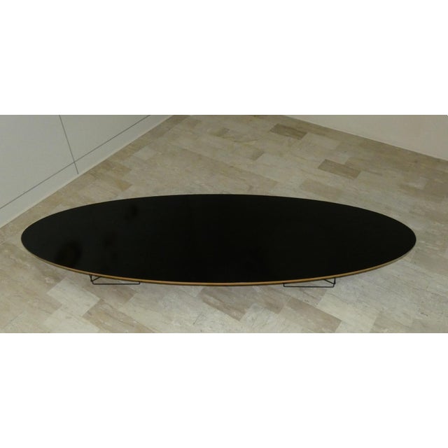 An imposing coffee table with a black laminated plywood top and eiffel metal bases. It is in very good condition. This...