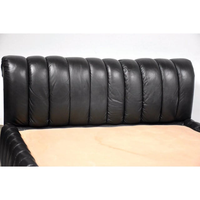 A beautiful post modern channeled black leather bed designed by Jay Spectre for Century Furnitue. No rips or tears. The...