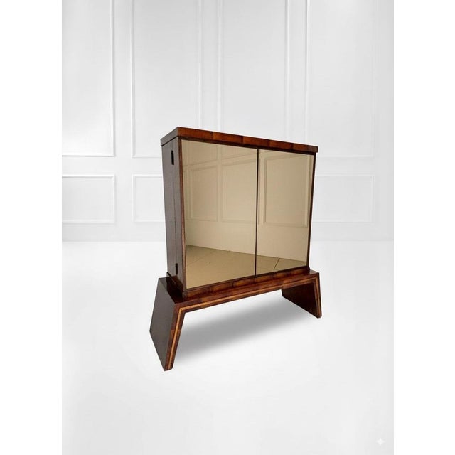 An elegant Italian dry bar, crafted from dark wood with a high-gloss finish. The bar features two mirrored doors that...