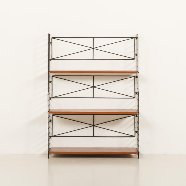 This scandinavian freestanding shelving unit is a part of the "string" system designed by kajsa and nisse strinning....