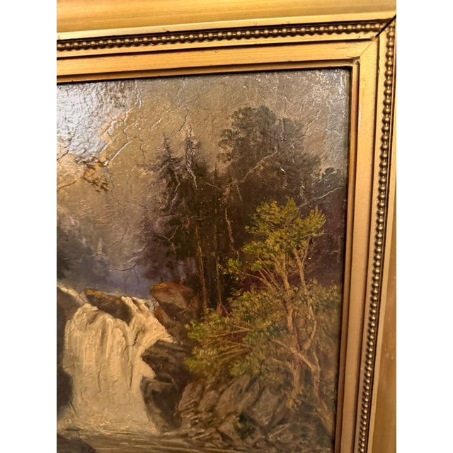 19th-century European oil painting on board depicting a picturesque Alpine landscape with a waterfall surrounded by rugged...
