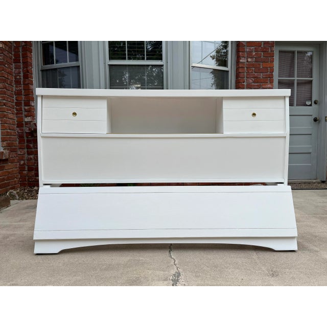 A beautiful newly painted full size head and footboard. The headboard is in a bookcase style with sliding doors and three...