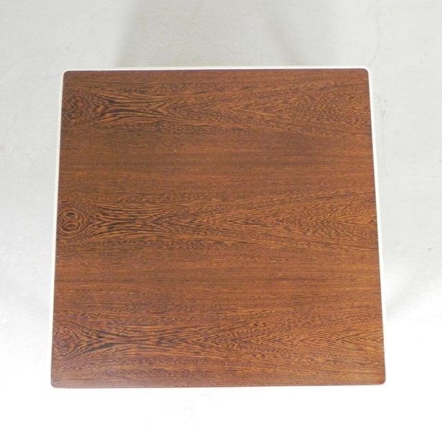 This 1960s coffee table features a wenge wood top, recognizable by its dark shade and even grain. The design follows the...