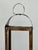 This antique handcrafted copper lantern features a simple open-frame design with a curved hood, loop handle, and rich aged...