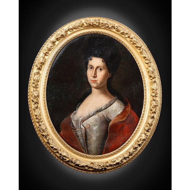 Description: An antique oil painting on canvas with a period gilded and carved wooden frame depicting a French noblewoman....