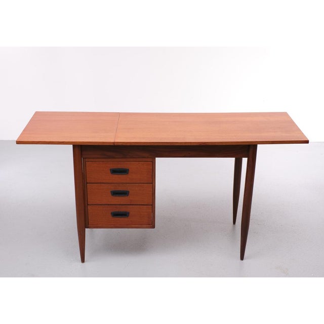 This writing desk was designed by Arne Vodder and was produced in Denmark in the 1960s. It is made from teak and features...