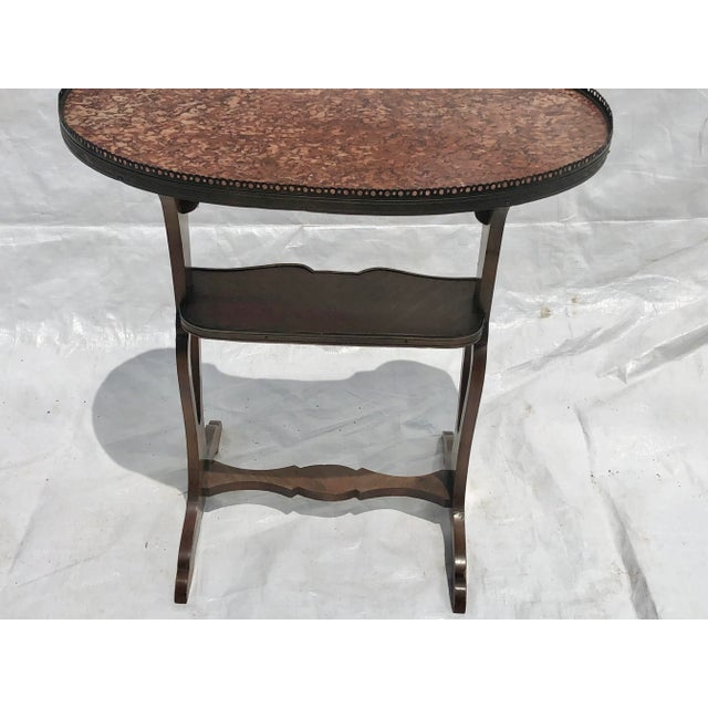 Charming French walnut kidney shaped marble top with a pierced brass gallery top.