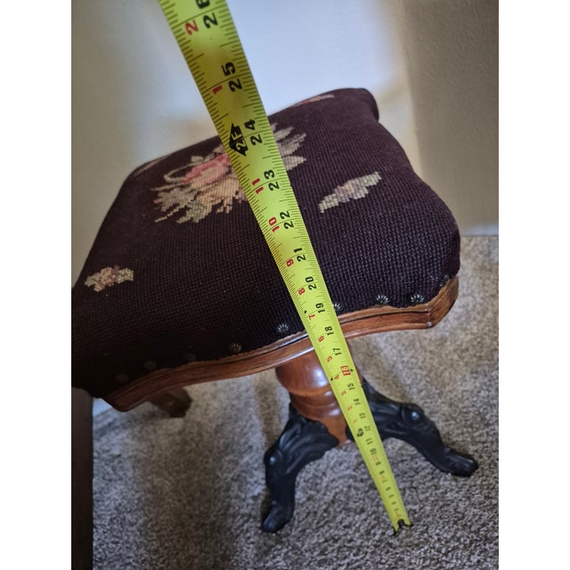 This antique piano stool features distinct Victorian design elements from the late 19th or early 20th century. Upholstered...