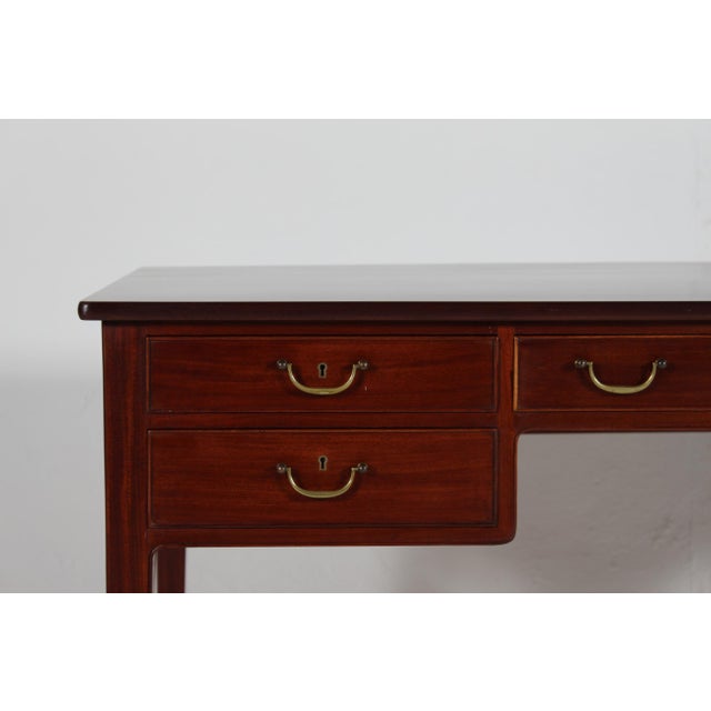 Free standing writing desk with 5 drawers designed by Ole Wanscher (1903-1985). The desk is made of lacquered mahogany...