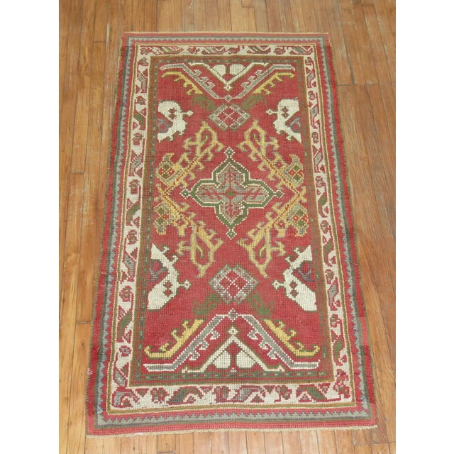 An early 20th-century small runner oushak Turkish rug. This piece is a true antique, one-of-a-kind rug that has been...