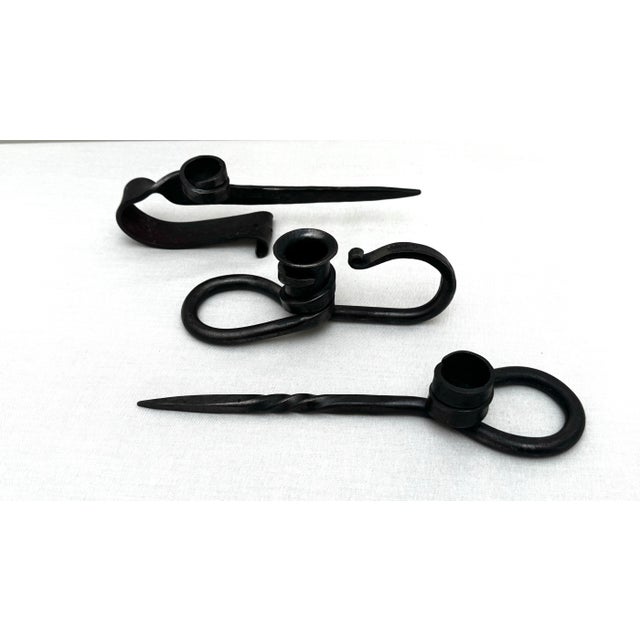 Unique craftmanship is exhibited within this set of three hand-forged iron taper candle holders. Fashioned in Brutalist to...