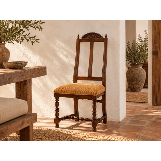 A carved shell crest sits between two turned finials above a pair of tall, curved slats, so this chair stands taller than...