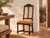 A carved shell crest sits between two turned finials above a pair of tall, curved slats, so this chair stands taller than...