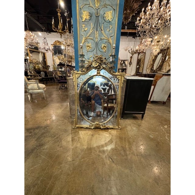 The product is a 19th century French Louis XV giltwood mirror with etched border panels. This mirror exudes elegance and...