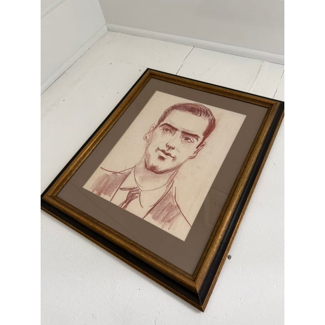 Unsigned red chalk on paper portrait circa 1930-1950. Presented in vintage frame.