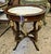 Add a touch of refined French elegance with this distinctive oval side table, featuring a rich, high-gloss wood finish, an...