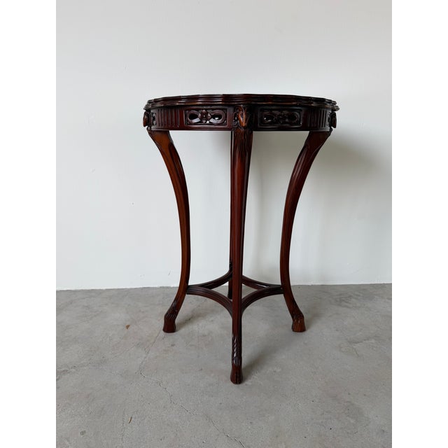 Elegant vintage regency - style side table featuring finely carved ram head accents at each corner, adding a bold...