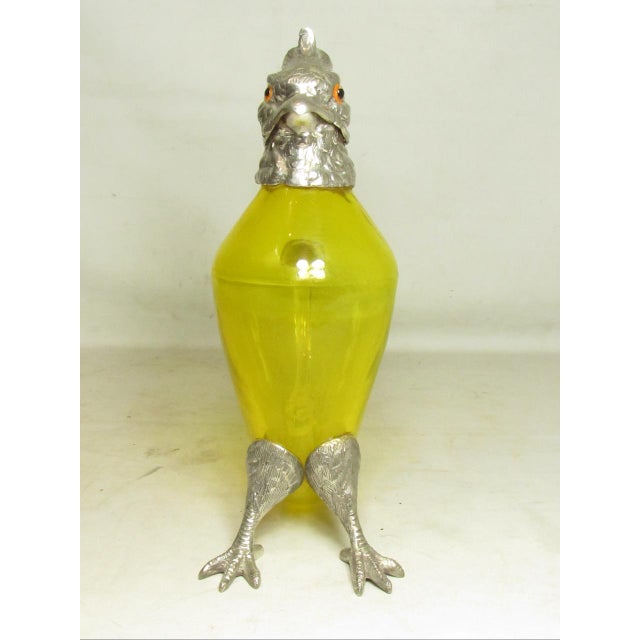Antique English wine or claret decanter, in the form of a cockatoo, c.1900 Having a translucent yellow glass body and...
