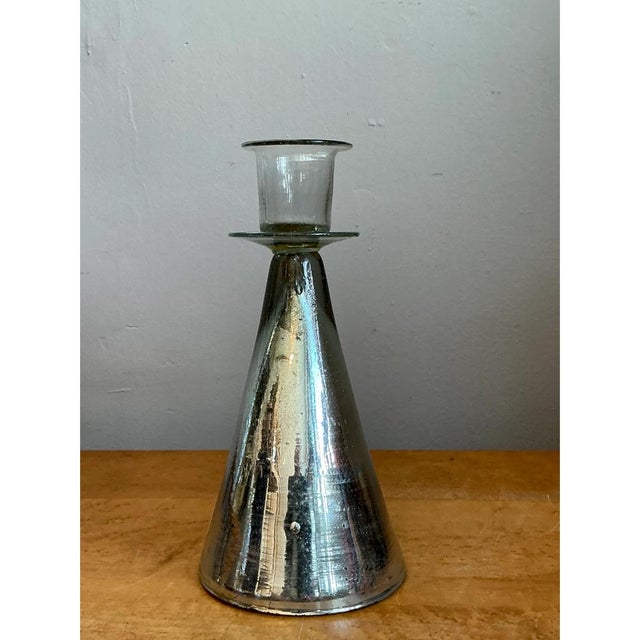 This vintage candle holder is a study in simple geometry, with a tall, smooth cone of mercury-style silvered glass rising...