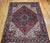 "This vintage Persian Heriz rug from the second quarter of the 20th century showcases a vibrant brick-red field anchoring...