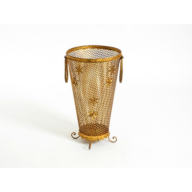 Beautiful, large, and elegant Mid-Century Regency umbrella stand made of gilded metal. Made in Italy. Crafted from...