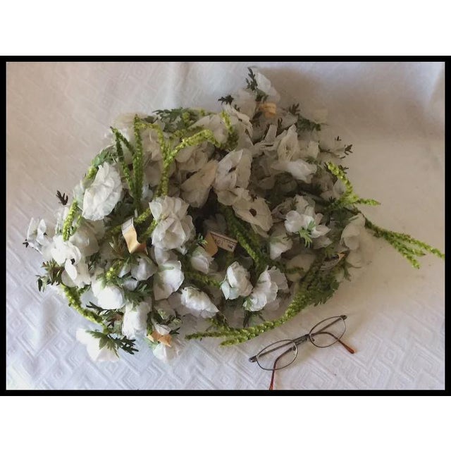 A beautiful group of vintage white silk flowers. The flowers are made of fabric that look like linen or a silk blend and...