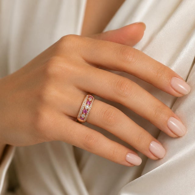18k Rose gold band ring with 0.75 carats of round pink sapphires and 0.6o carats of round white diamonds. 5.27 grams size...