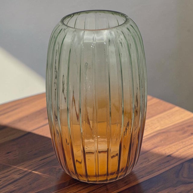 This Fluted Glass Vase features an ombre color gradient, with the top in green and the base in amber-orange. Standing at...
