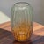 This Fluted Glass Vase features an ombre color gradient, with the top in green and the base in amber-orange. Standing at...