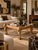 Striking vintage Egyptian Revival coffee table featuring a sculptural hand-carved wood frame supported by four impressive...