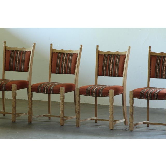 A characterful set of four vintage oak dining chairs with a strong Scandinavian folk-modern feel. The combination of solid...