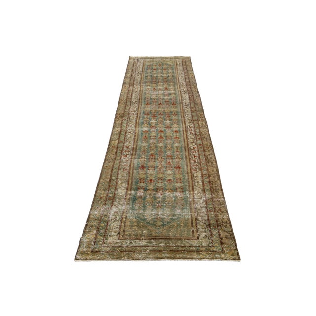 This Persian Malayer wool rug possesses an antique allure. It showcases hand-knotted wool in a teal color field. The...