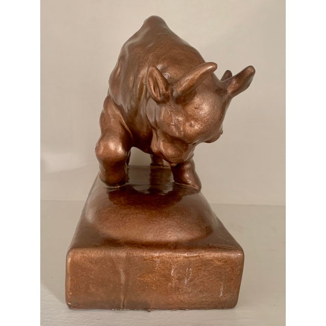A bronzed, ceramic, sculptural statue of a charging bull. Beautifully proportioned and muscular this bull is ready for...