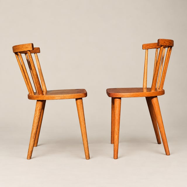 A charming pair of Swedish pine spindle-back dining chairs, circa 1970s. Featuring gently curved crest rails, slender...
