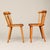 A charming pair of Swedish pine spindle-back dining chairs, circa 1970s. Featuring gently curved crest rails, slender...