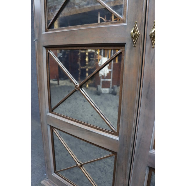 Features smoked mirror glass panel doors with a fully fitted cherry interior. Includes adjustable shelving, divided...