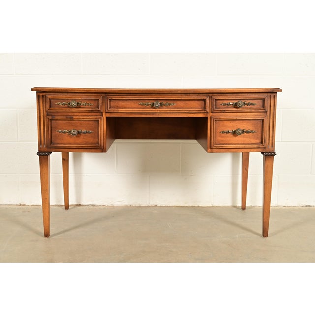 A gorgeous French Regency Louis XVI style writing desk or bureau plat desk By Sligh Furniture USA, Circa 1960s Carved...