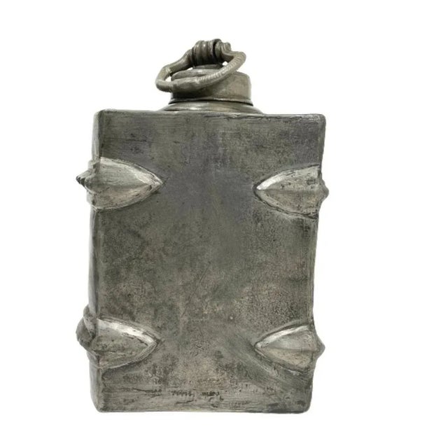 A German pewter decanter in the shape of a book A pewter decanter in the shape of a book. German decanter, marked with B....