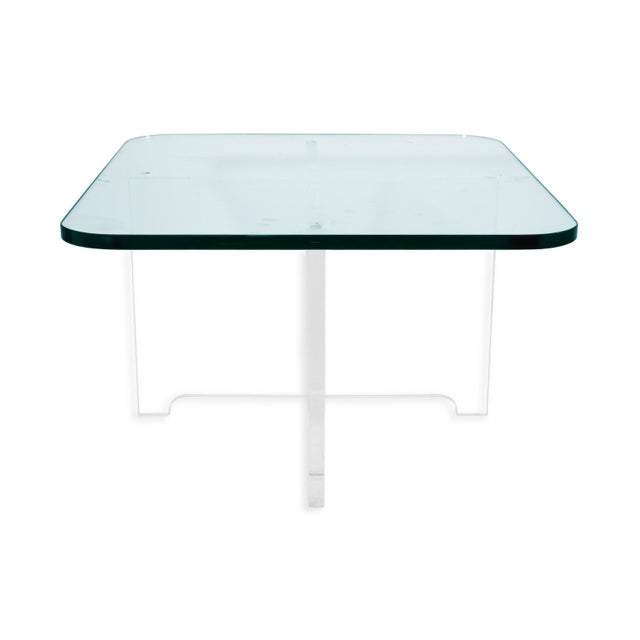 A striking example of mid-century modern design, this dining table features a thick beveled glass top resting on a...
