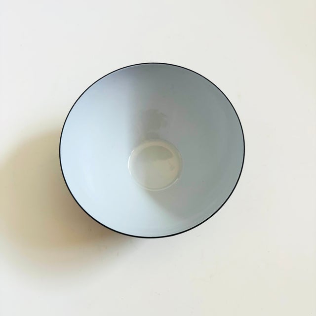 A mid century vintage enameled metal bowl. White enameled interior with a matte dark gray finish to the exterior metal....