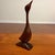 Vintage carved wood bird sculpture with a beautifully elongated, minimalist form. This abstract mid-century figure has a...