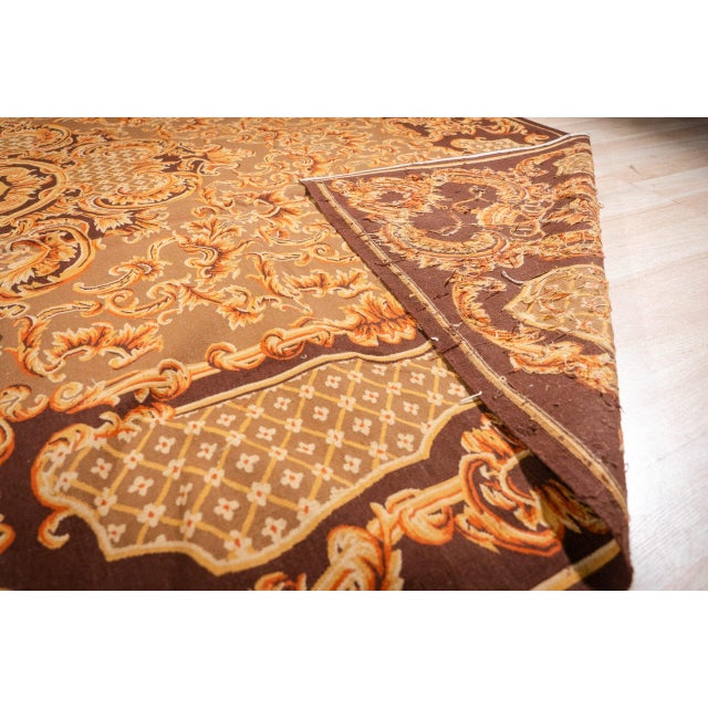 Vintage Aubusson in a bold baroque design. Rust, gold and cream strapwork and acanthus scrolls cover a deep chocolate...