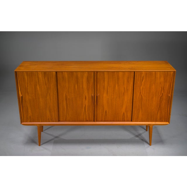 Elegant Danish Model 19 highboard produced by Omann Jun, Denmark, 1960s, attributed to Gunni Omann. This iconic...