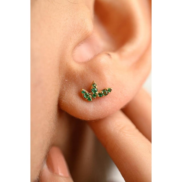 This is part of Chairish’s Fine Jewelry assortment. Three Petal Tiny Natural Emerald Stud Earrings in 18K Gold to make a...