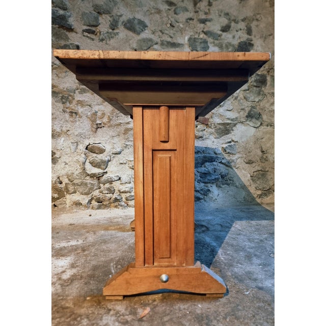 Vintage French bistro table dating from the 1930s. The table features a walnut top with a beechwood base, joined by a...