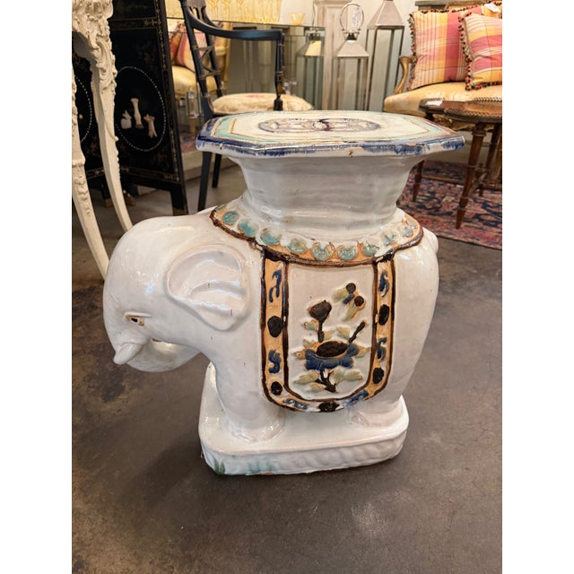 An exceptional pair of mid-to-late 20th-century Chinese export ceramic elephant garden stools (or side tables)....
