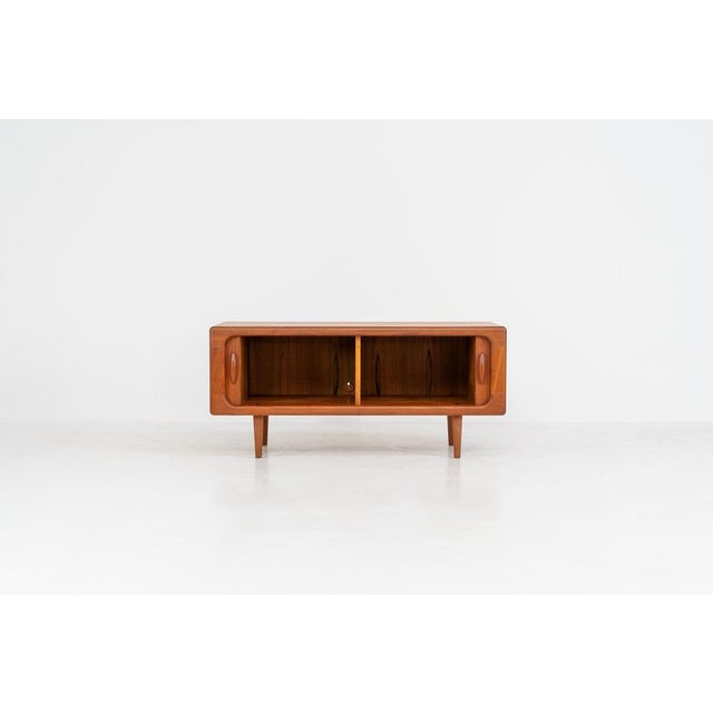 Beautiful lowboard with tambour doors by Svend Dyrlund (Denmark, 1960s). This elegant Danish piece, crafted in teak,...