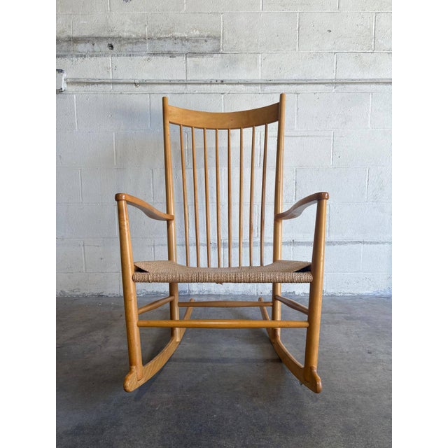 This classic rocking chair features a tall spindle back and sweeping curved armrests. Its timeless aesthetic highlights...
