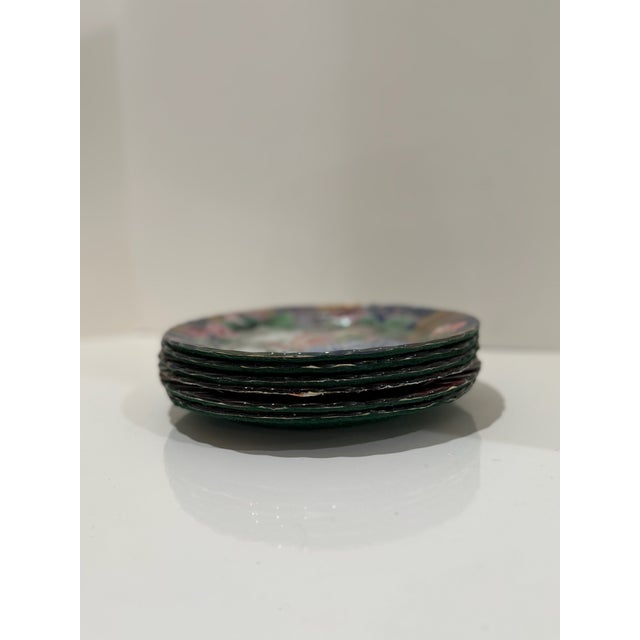 Striking set of eight hand-decorated art plates featuring richly layered decoupage imagery. Each plate is uniquely...
