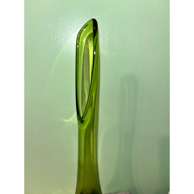 Striking Mid-Century Modern swung glass vase featuring an elegant elongated neck with an oval stretched opening and a...